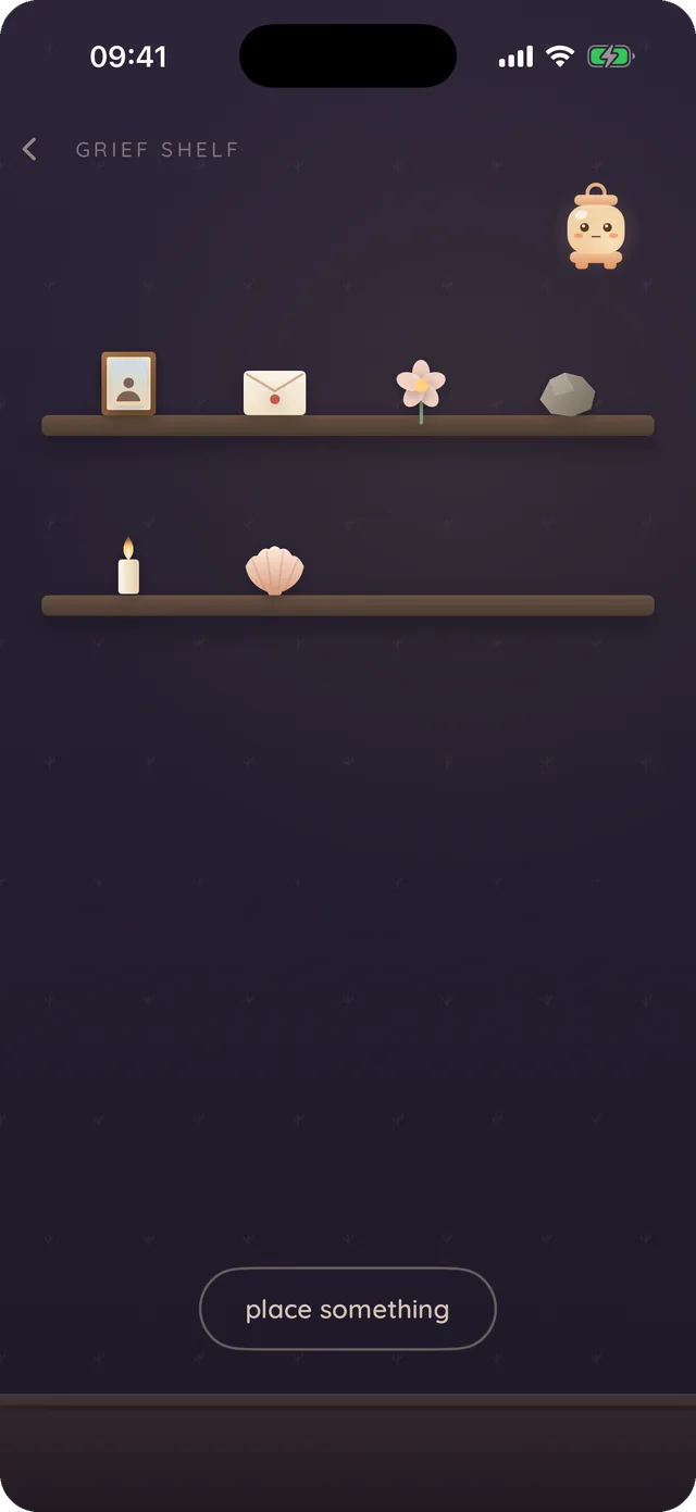 The grief shelf: two candle-lit wooden shelves holding a framed photo, an envelope, a flower, a stone, a candle and a shell, with Luma resting small and dim to one side